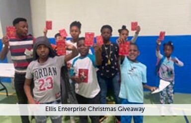 The Ellis Enterprise Christmas Giveaway. Children stand in a group holding up their prizes.