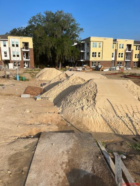 Piles of dirt and sand in front of Orange Avenue construction.