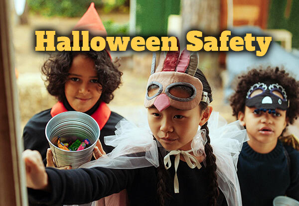 Text at the top says Halloween Safety. Three kids are in costumes and knocking at the door to trick-or-treat.
