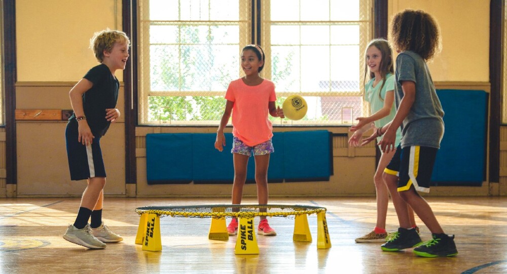 Children playing spike ball in a gym