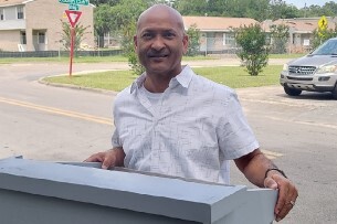 Mr. Marco Moo Young holding a box