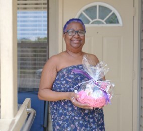 Resident Deborah Adams holding a gift.