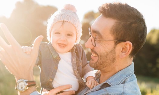  A dad holding a baby.