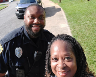 The Friendly Face of Security off duty officer smiles with a local citizen.