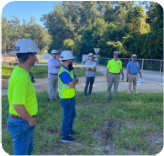 Orange Avenue contractors stand together discussing their future plans. 