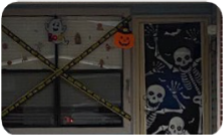 Caution tape criss-crosses in front of the window and skeletons cover the door of a Pinewood Place residence.