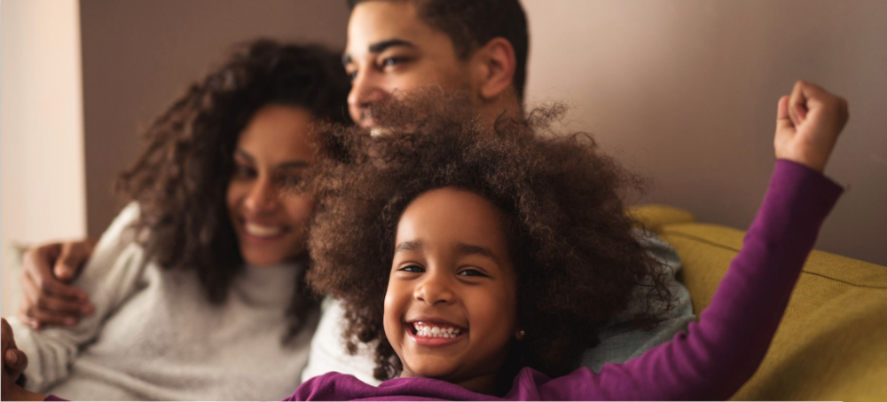 Family sitting on a couch.