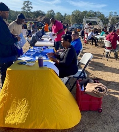 People sitting at tables talking to other people looking for jobs.