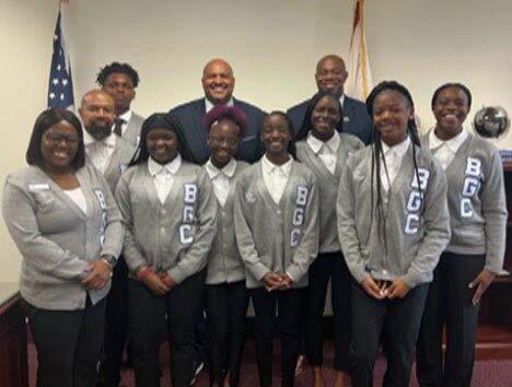 Group of smiling scouts in silver and grey sport coats. 