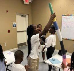 Girl stacking items on top of each other in an activity. 