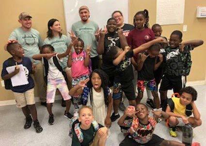 A group photo of children and volunteers.