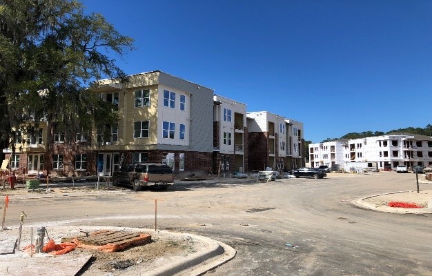 Corner apartment picture at an intersection of streets. 