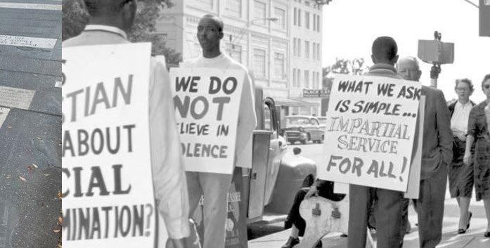 Men standing with signs in protest. 