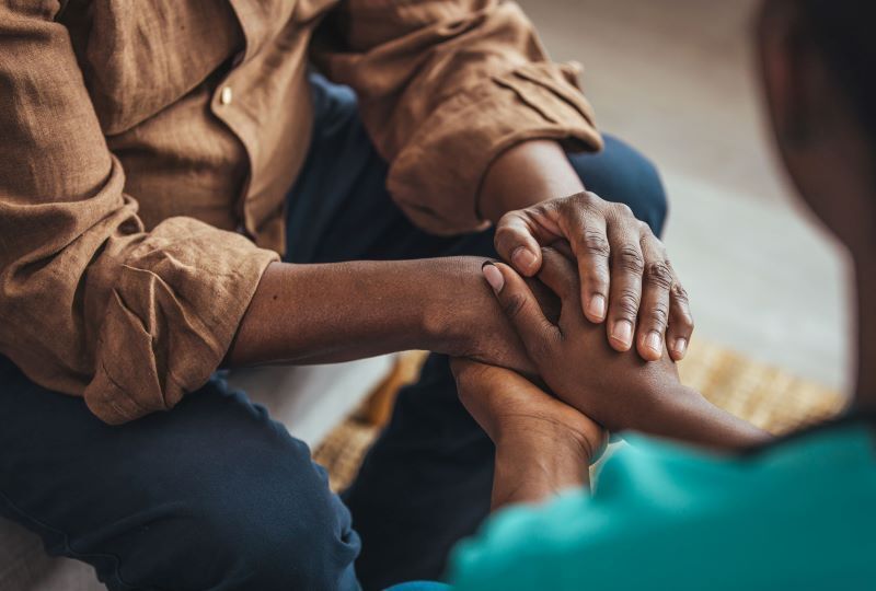 African American hands intertwined with each other. 