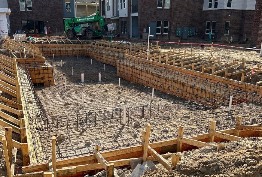 Early construction of the community Pool shown.