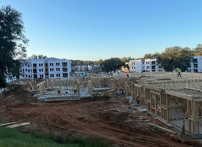 Continued frame work of apartments and outside view of construction area.