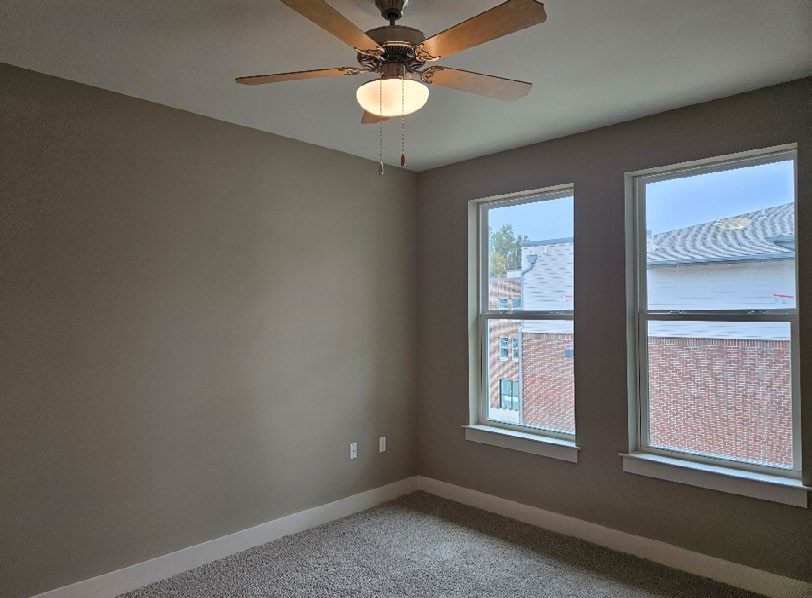 Finished interior of a bedroom shown.