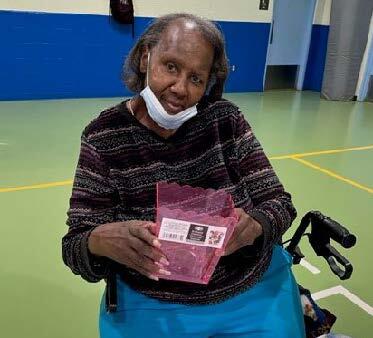 Woman holding a Bingo prize.