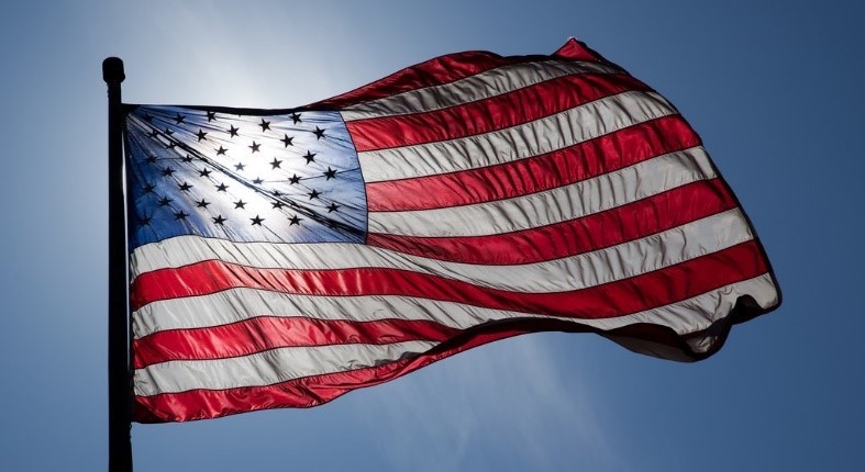 American flag waving in blue sky