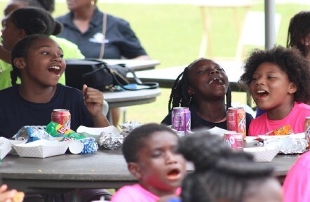 Kids sitting and laughing around a table.