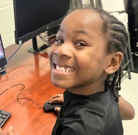 Z. Lee smiling by a computer.