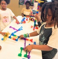 Kids building things at a table.