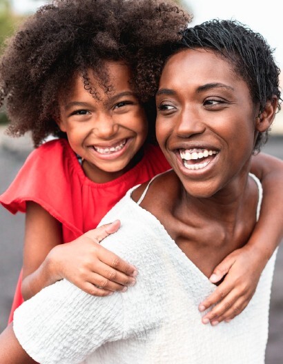 A woman holding a child on her back.