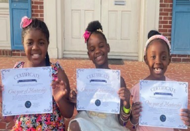 Three Girls holding certificates.