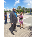 A man and a woman standing on a street corner and talking