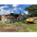 A tractor is tearing down a building in Phase 2.