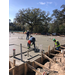 Three construction workers working on the foundation for a Building on Orange Ave.