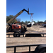 A crane delivering a a site lighting conduit to the Orange Ave site.