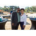 Man and woman smiling with tables. 