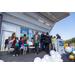 Group presenting with balloons on a stage. 