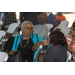 Two women conversing in the audience. 