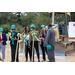 Group in hard hats with shovels.