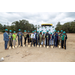 Wide shot of pose with shovels and hard hats. 