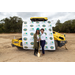 Two women pose with shovel and hard hat. 