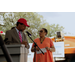 A man speaking into a microphone while looking at a woman standing next to him.