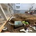 A construction worker installing a laundry room lint trap. 