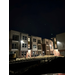 Exterior view of the apartments at night. 
