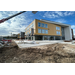 A side view of construction on a leasing office.