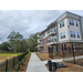 A view of a sidewalk leading up to new apartment buildings.