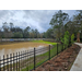 A view of a body of water on the other side of a fence.