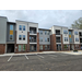 A view of the parking lot of an apartment building.