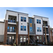 The front view of newly constructed apartments and palm trees.