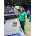 Woman talking in front of a tradeshow table. 