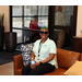 Woman smiling while sitting on a chair.