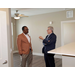 Two men talking in one of the apartments. 