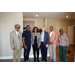 A group posing and smiling in a new apartment. 